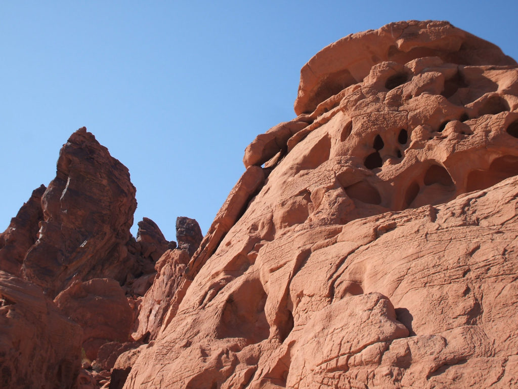 Orange and rust coloured rock formations against a clear blue sky at the Valley of Fire State Park, Nevada